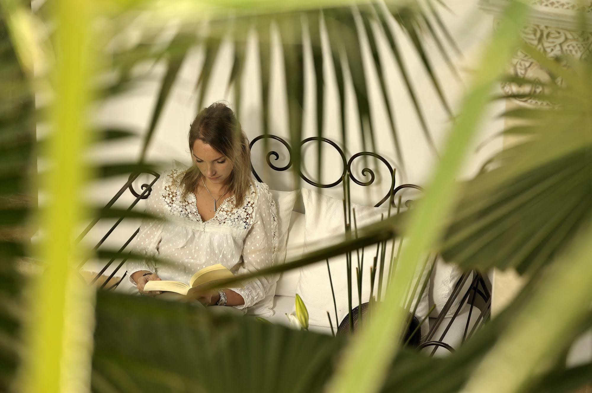 Riad Le Jardin D'Abdou Marrakesh Eksteriør billede A woman reading a book in the garden